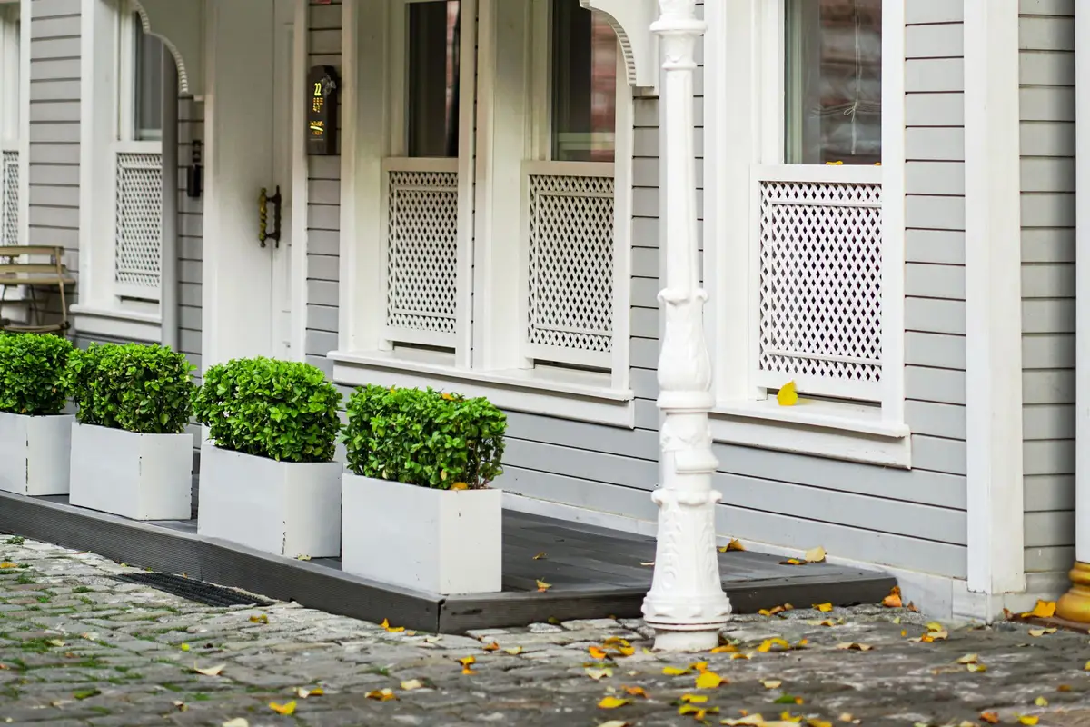House exterior with new gray lap siding, white trim and a decorative lantern
